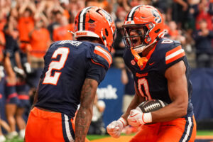 Tight end David Clement celebrated with teammate Umari Hatcher after he scored a touchdown.