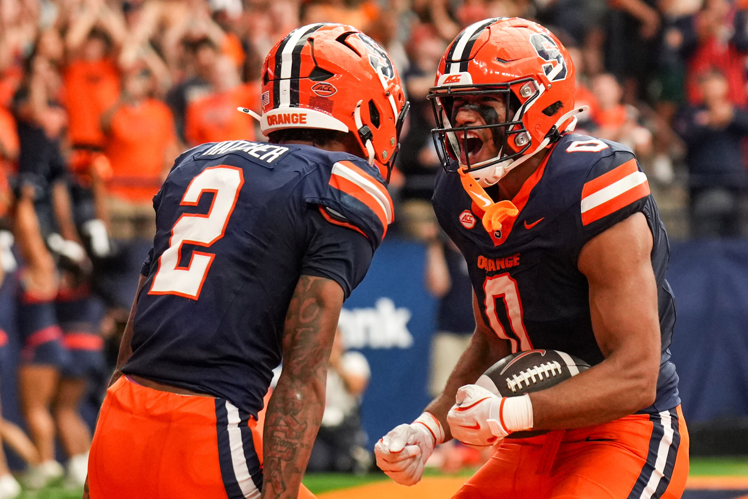 Tight end David Clement celebrated with teammate Umari Hatcher after he scored a touchdown.
