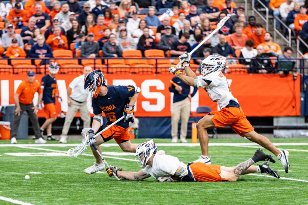 The Syracuse University Men’s Lacrosse team faced off against the University of Virginia on Saturday, April, 11, 2026. Face-off John Mullen dove to get the ball from Virginia midfielder Owen Crann.