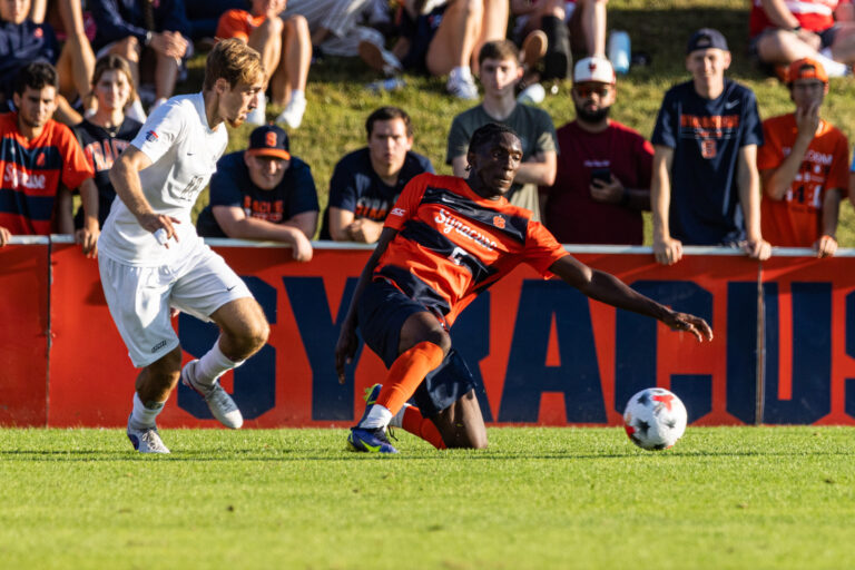 SU defender Chimere Omeze slides for the ball in front of his goal during Syracuse University men’s soccer team faced off against the University of New Hampshire on Sunday, August, 23, 2026.