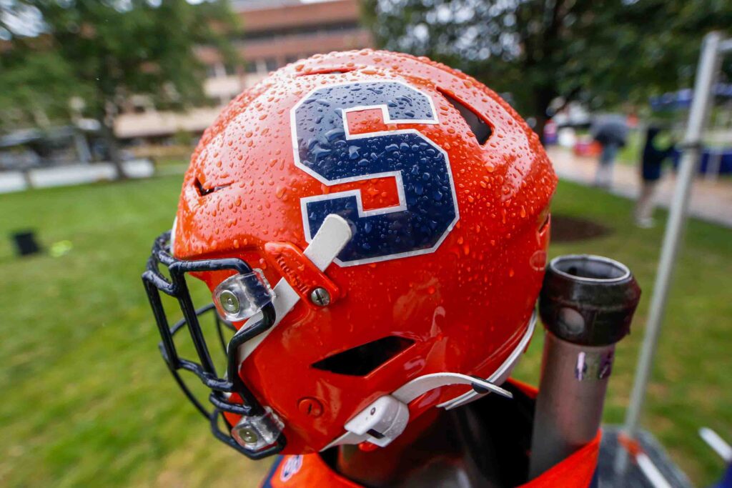 A Syracuse football helmet in the rain Saturday ahead of the home opener game against UConn.