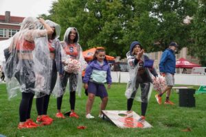 Syracuse fans and cheerleaders play cornhole on campus during the 'Cuse on the Quad tailgate event Saturday before the football team's home opener game against UConn. (Photo by Jack Henry / Newhouse School)