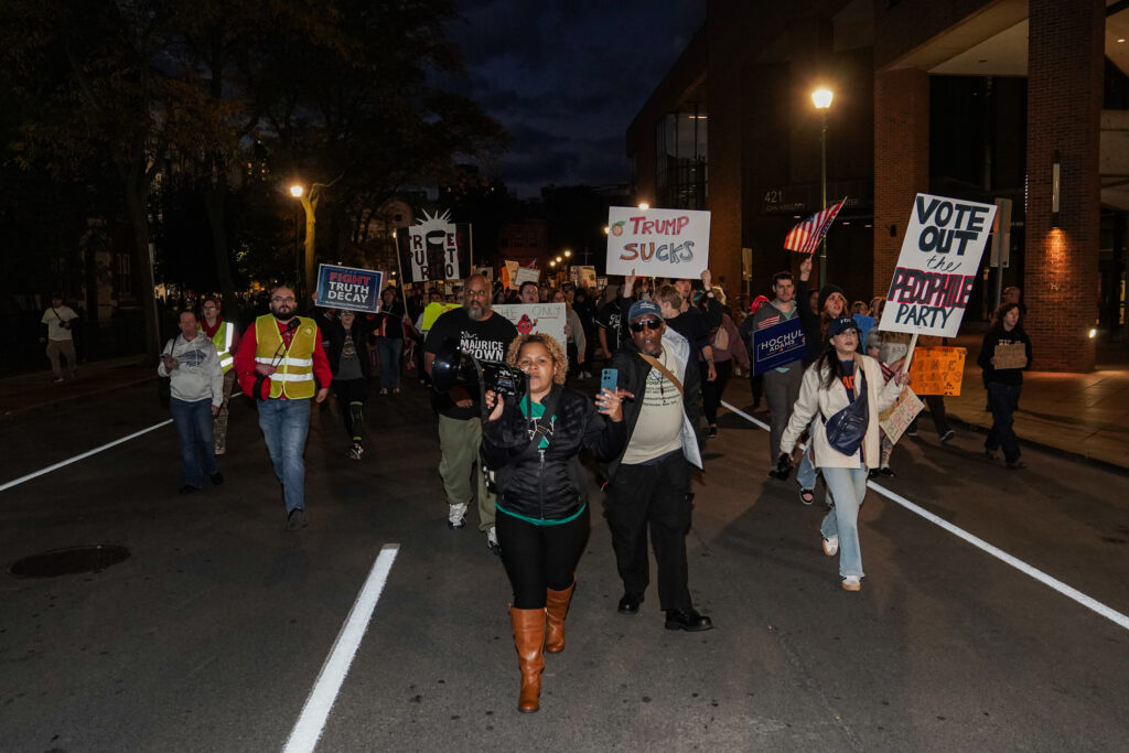 Anti-Trump protesters march through the streets of Syracuse towards the Oncenter, the location of Trump's rally, on Friday, Oct. 9, 2026.