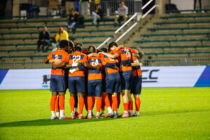 SU Men's Soccer huddles on the field at Thursday's semifinal game versus SMU.