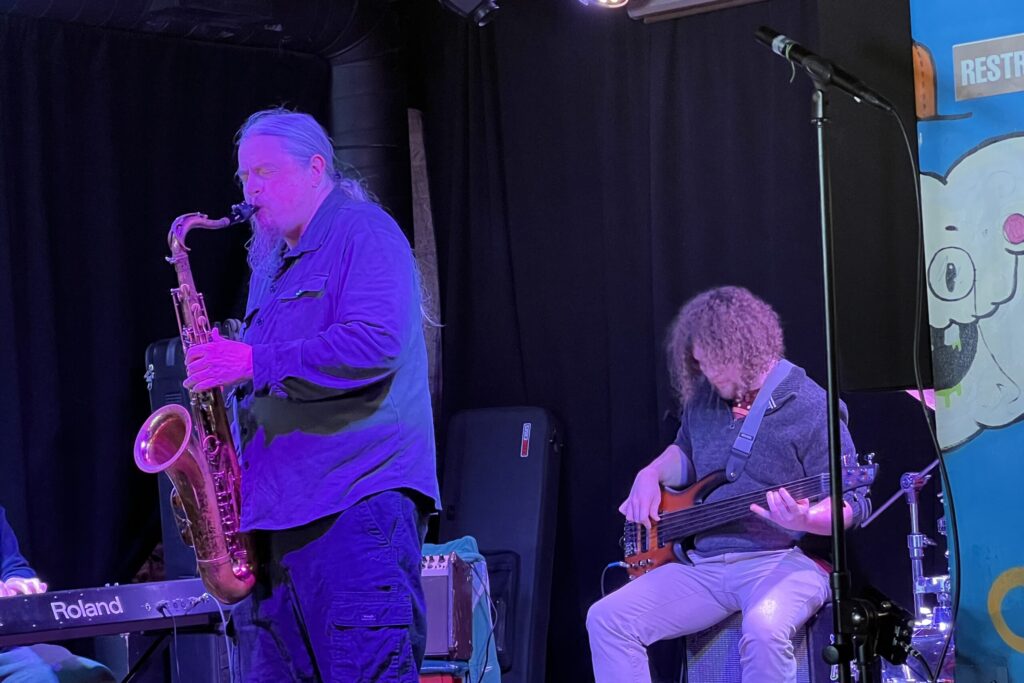 At the weekly Jazz Jam event at Funk n' Waffles, a saxophone player has a solo onstage.