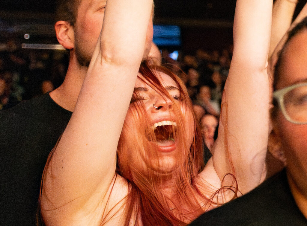 A fan screams as the opening guitar chords of 