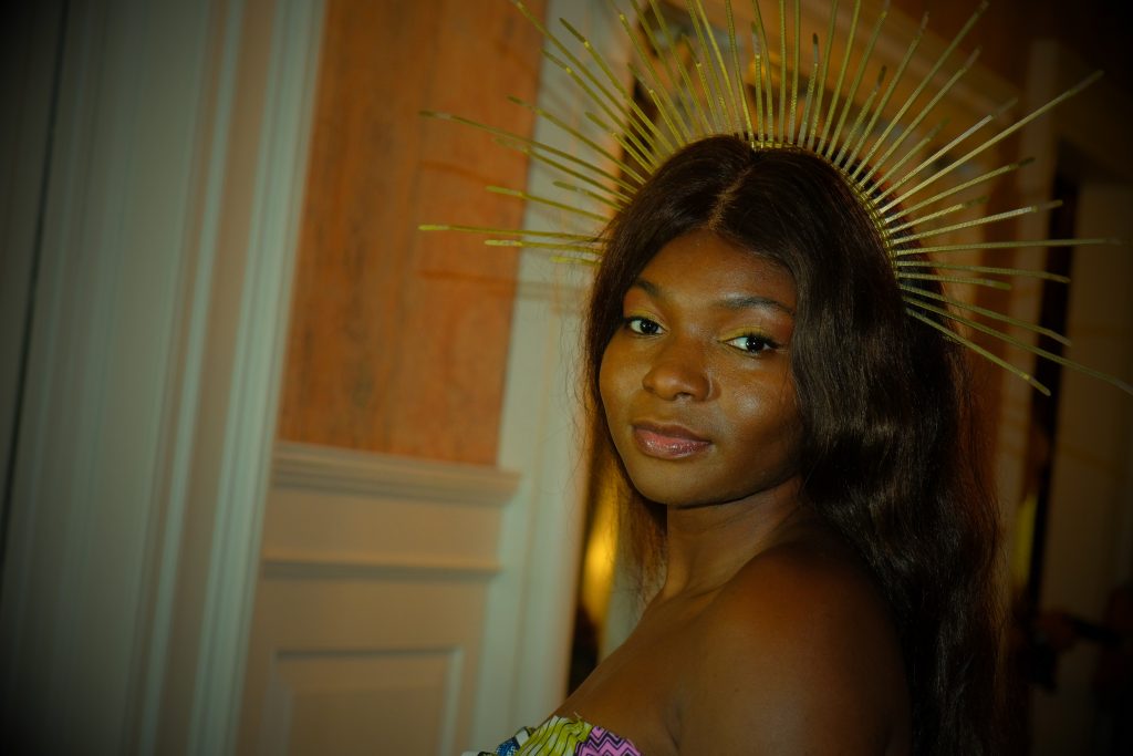 Shenice Mobley, designer of Akua, wears her own two piece and crown down the runway.