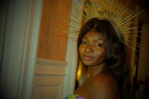 Shenice Mobley, designer of Akua, wears her own two piece and crown down the runway.