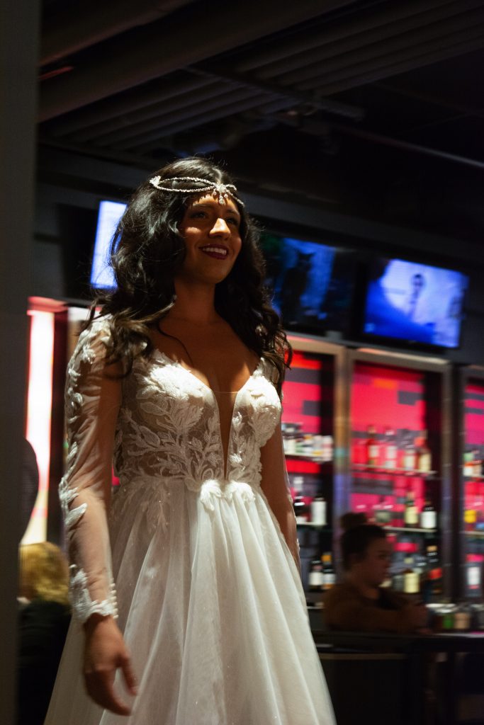 A model walks down the runway at Syracuse Fashion Week.