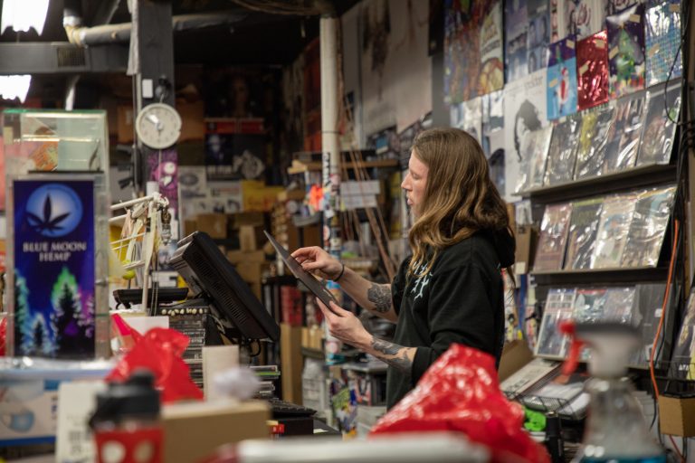 Casey Keefe looks at vinyl record at The Sound Garden on 11/8/21. (Photo by Max Mimaroglu)