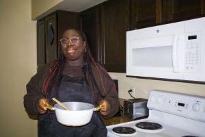 Zoe Selesi makes curry in her apartment.