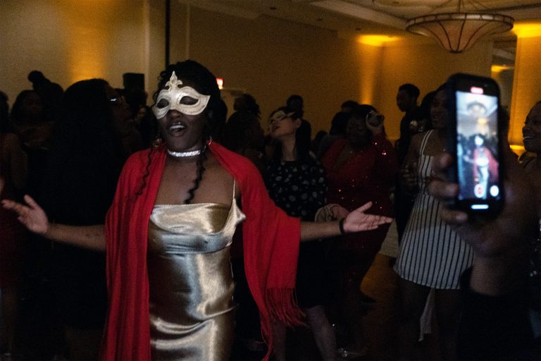 A girl dances for the camera at the party.