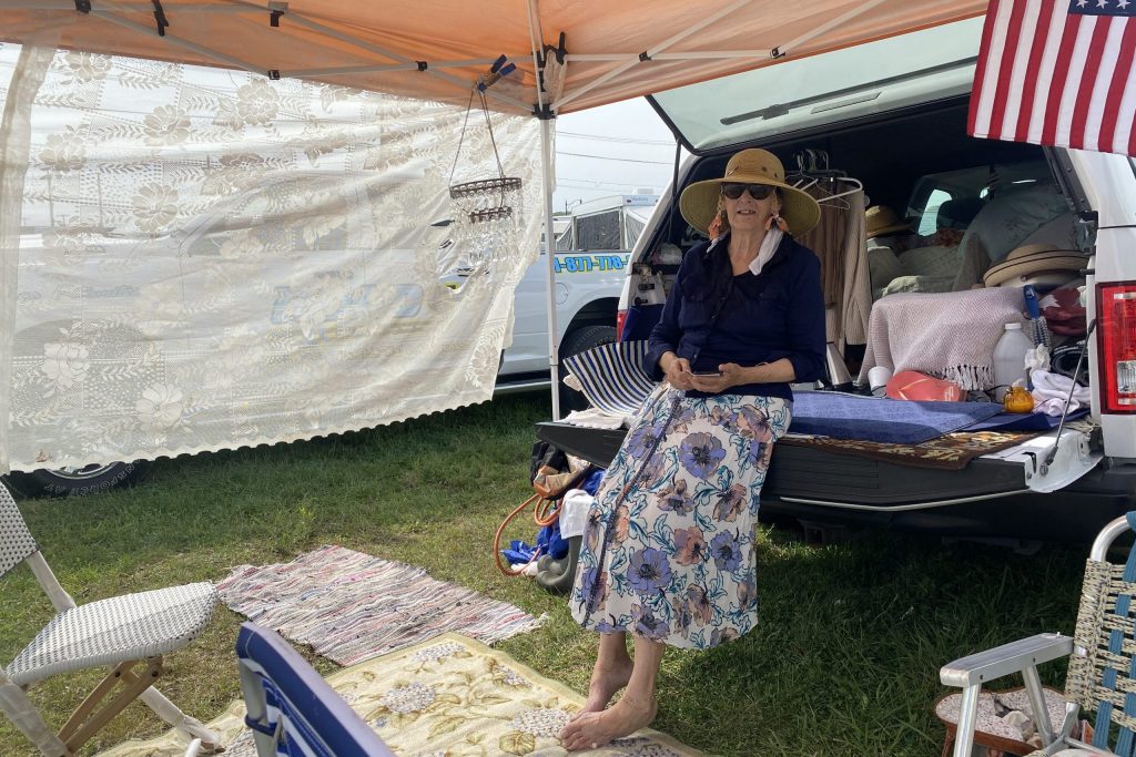 Ruth Stanley in the bed of her car she revamped into a makeshift camper.
