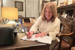 Lorraine Morganti free writes in her journal in the front parlor of her 1926 Eastwood home.