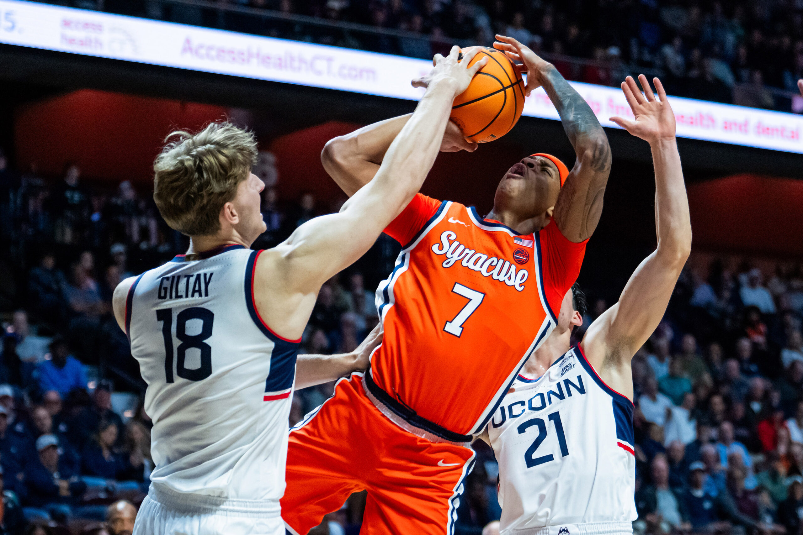Kiyan Anthony #7 of the Syracuse Orange shoots against Oskar Giltay #18 of the Connecticut Huskies during the first half of the NCAA men's exhibition basketball game at Mohegan Sun Arena on October 13, 2026 in Uncasville, Connecticut.