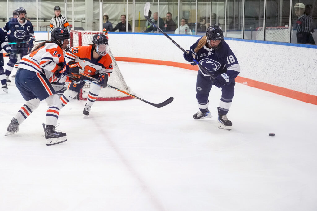 Syracuse players skate toward the play as Penn State player focuses on the puck at Tennity Ice Pavilion, Saturday, Oct. 10, 2026.