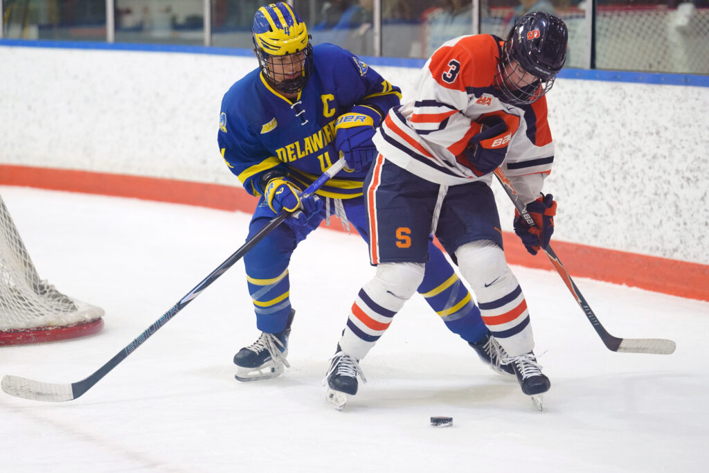 Syracuse forward Emma Gnade (3) protects the puck from Delaware’s captain behind the net on Thursday, Oct. 29, 2026, at Tennity Ice Pavilion in Syracuse, N.Y.