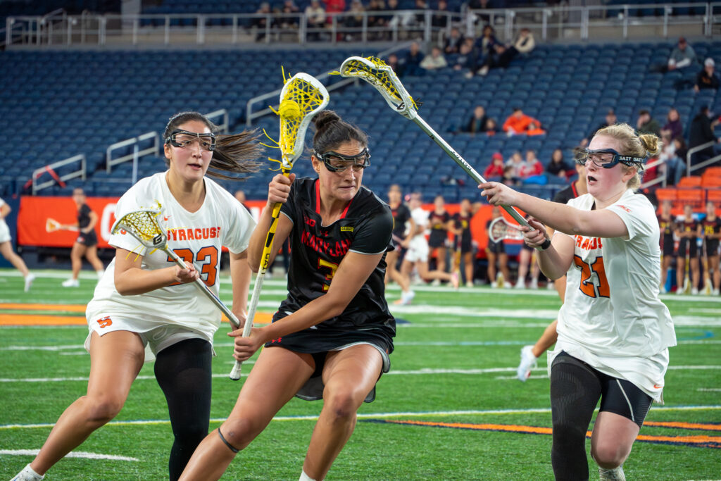 Syracuse attack Ashlee Volpe tries to get the ball out of Maryland midfielder Emma Abbazia's stick on Friday, Feb 6, 2026, at the JMA Wireless Dome.