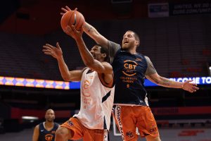 Eric Devendorf, right, comes soaring in from behind to block Lawrence Moten's layup attempt during the 2021 Coming Back Together (CBT) Celebrity Classic, Thursday, at the Carrier Dome.