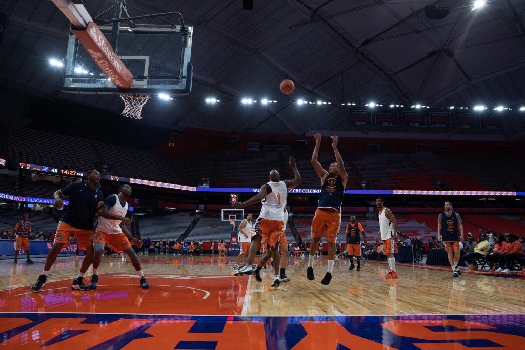 Mookie Jones, right, elevates in the air before releasing a jumper over the outstretched hand of Jamont Kinds.
