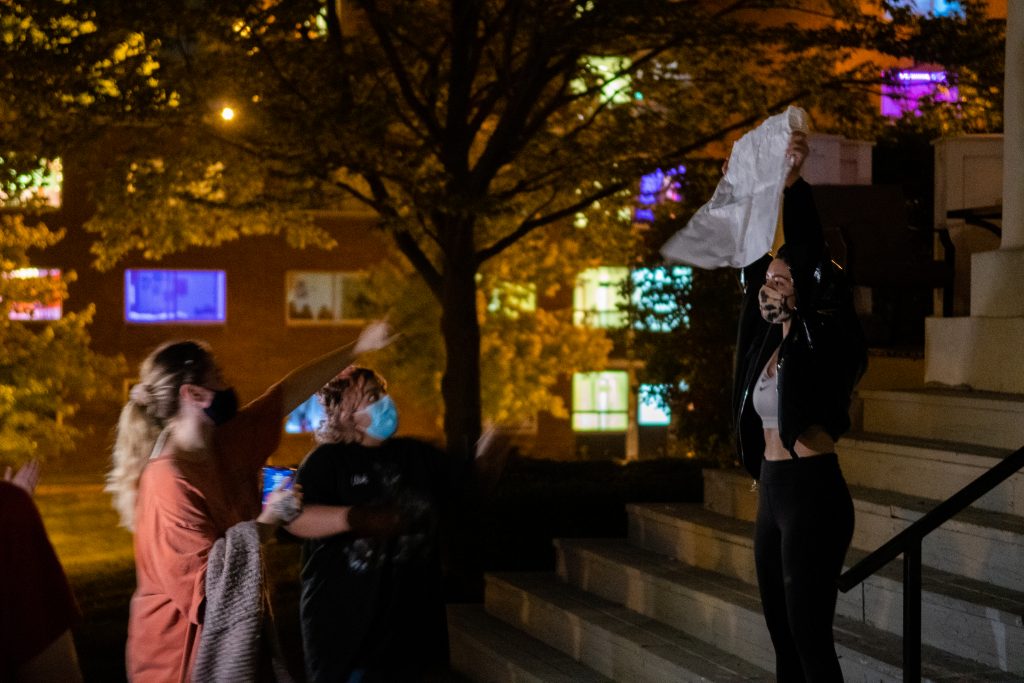 Students hold up hand-made signs to protest recent allegations of sexual misconduct.