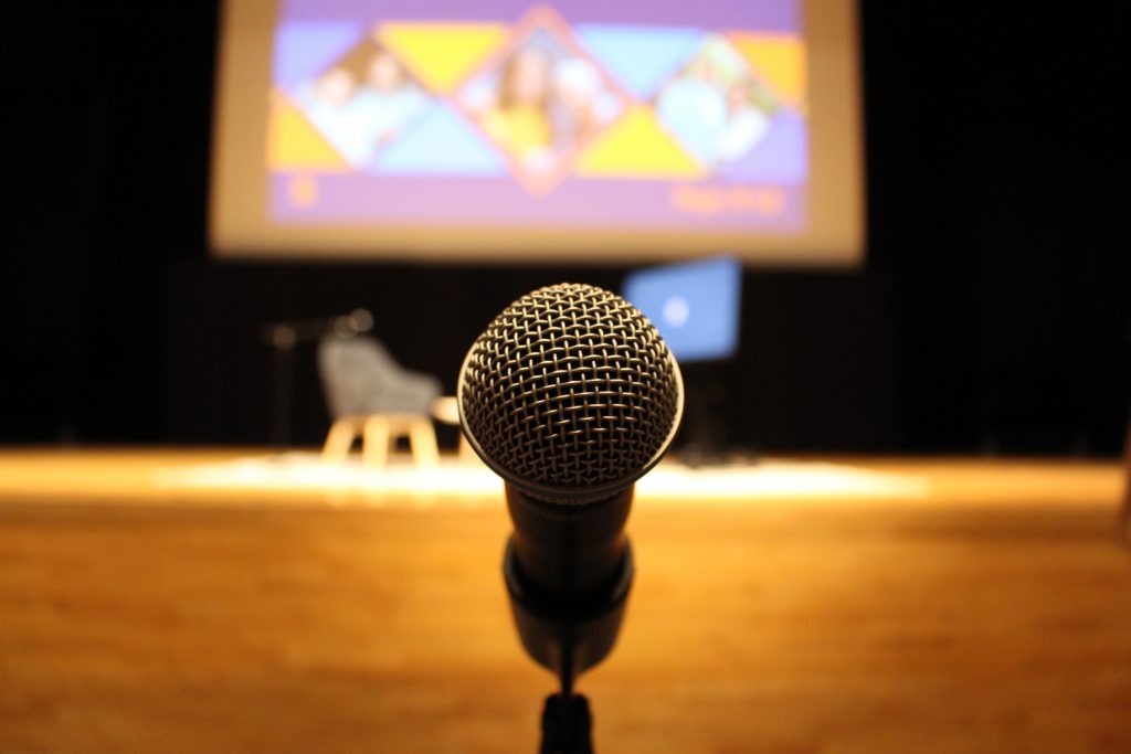 A microphone stands in front of the stage at a Coming Back Together lecture featuring actress, dancer and singer Rita Moreno on Thursday, September 9, 2021 in SU’s Goldstein Auditorium. Coming Back Together (CBT) started in 1983 as a way to bring Black and Latino/a SU alumni together every three years to celebrate achievements and stay connected with the University. The theme of this year’s reunion is “Celebrating 151 Years of Black and Latino/a Excellence at SU”.