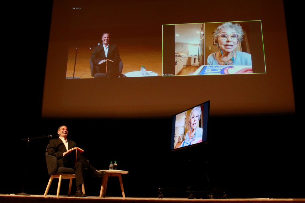 Associate Professor and Director of the Setnor School of Music Milton Rubén Laufer interviews actress, dancer and singer Rita Moreno at a Coming Back Together lecture featuring Moreno on Thursday, September 9, 2021 in Syracuse University’s Goldstein Auditorium. Coming Back Together (CBT) started in 1983 as a way to bring Black and Latino/a SU alumni together every three years to celebrate achievements and stay connected with the University. The theme of this year’s reunion is “Celebrating 151 Years of Black and Latino/a Excellence at SU”.
