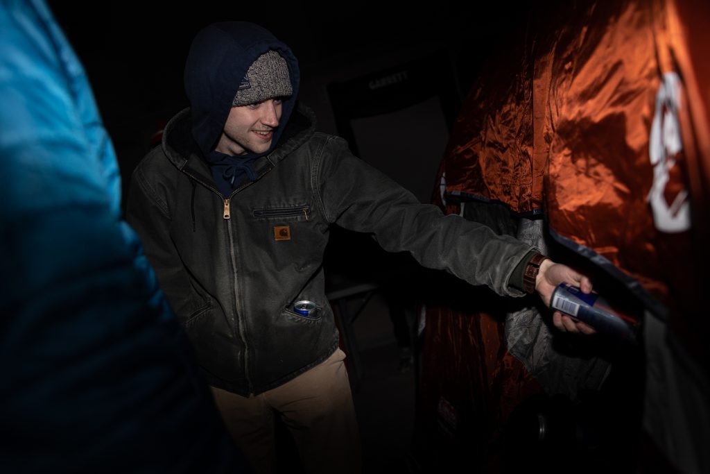 The RedBull representative gives out RedBull to a camper in Boeheimburg on Thursday.