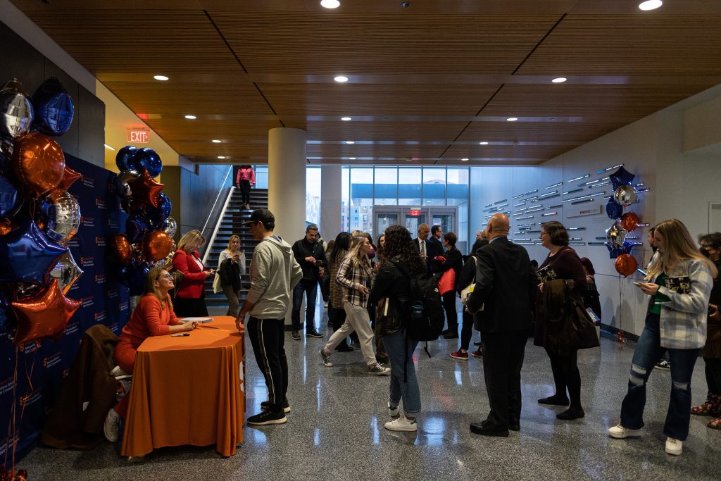 Katy Tur signs a book at the Gitner Symposium on October 18th, 2022.