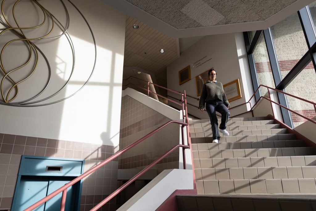 Sophia Moore walks down her street stairs towards the exit of 756 Irving Ave on September 30th, 2022.