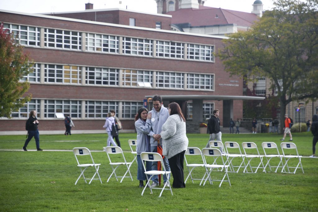 Remembrance Scholars Brielle Seidel and Jared Welch hug after the Sitting in Solidarity Display on October 17, 2022.