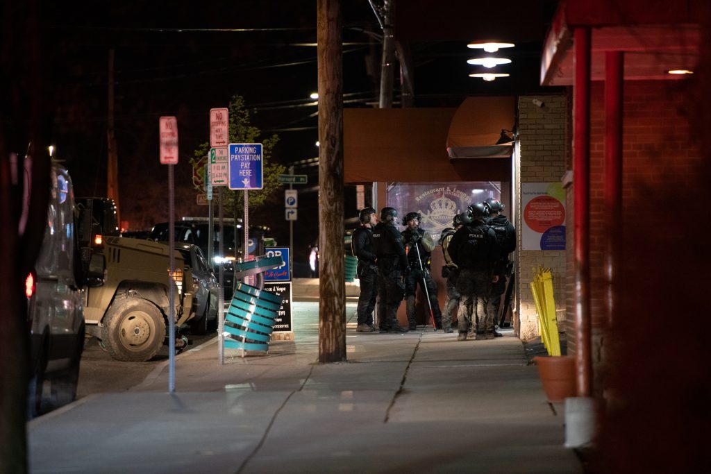 At approxiamtely 10:30 in the evening SWAT was still at the front door waiting. An SPD officer relayed information there were still a couple dogs inside they were waiting to recover. On Easter Sunday at 8:44 PM, Syracuse Police responded to a hostage situation involving one suspect a at least 2 hostages at Hitham's Pop Shop, a convenience store on Westcott St in Syracuse. Photo by Ryan Brady. Taken 4/17/22