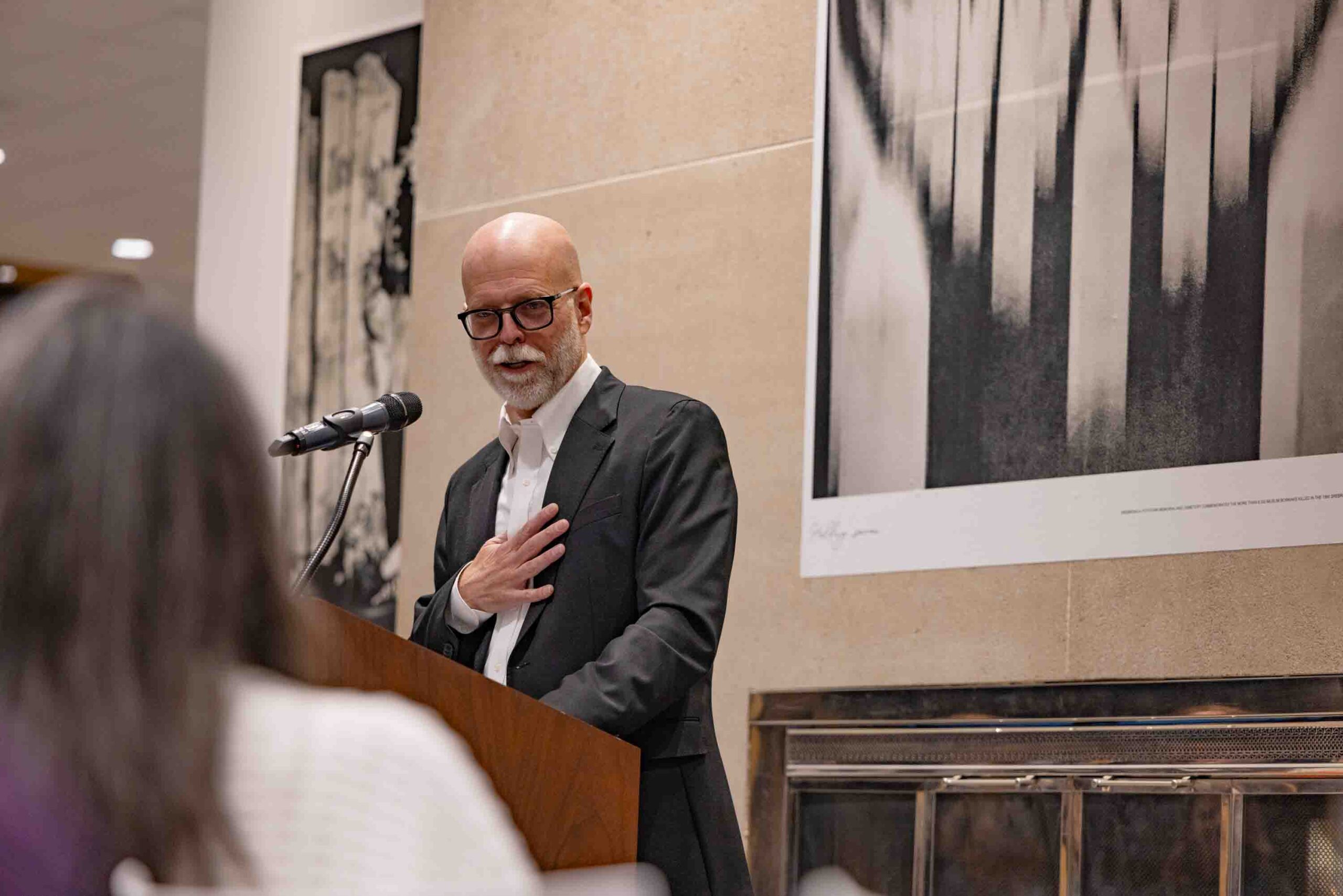 Bruce Strong, associate professor in Visual Communications at Newhouse and the Alexia Endowed Chair, speaks during the opening night of his Call to Me, Balkans photo exhibition in Panasci Lounge located on the third floor of Schine Student Center. The exhibition features photos, all of which were made on his iPhone, from his 2023 sabbatical and two successive trips to Bosnia. Claudia Strong, an adjunct in Visual Communications at Newhouse and also Bruce’s wife, curated and designed the exhibition.