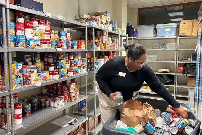 Leondra Tyler stocks the Coach Mac Pantry shelves during Hendricks Cup, a competition between SU fraternities.