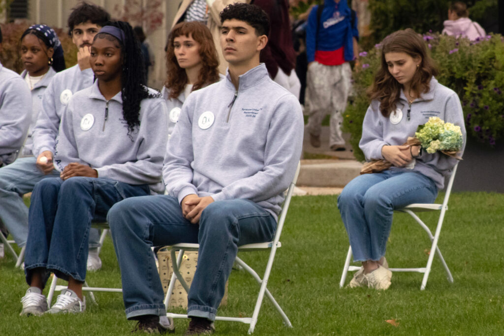 Some scholars held flowers while representing the Syracuse University students lost on PanAm flight 103