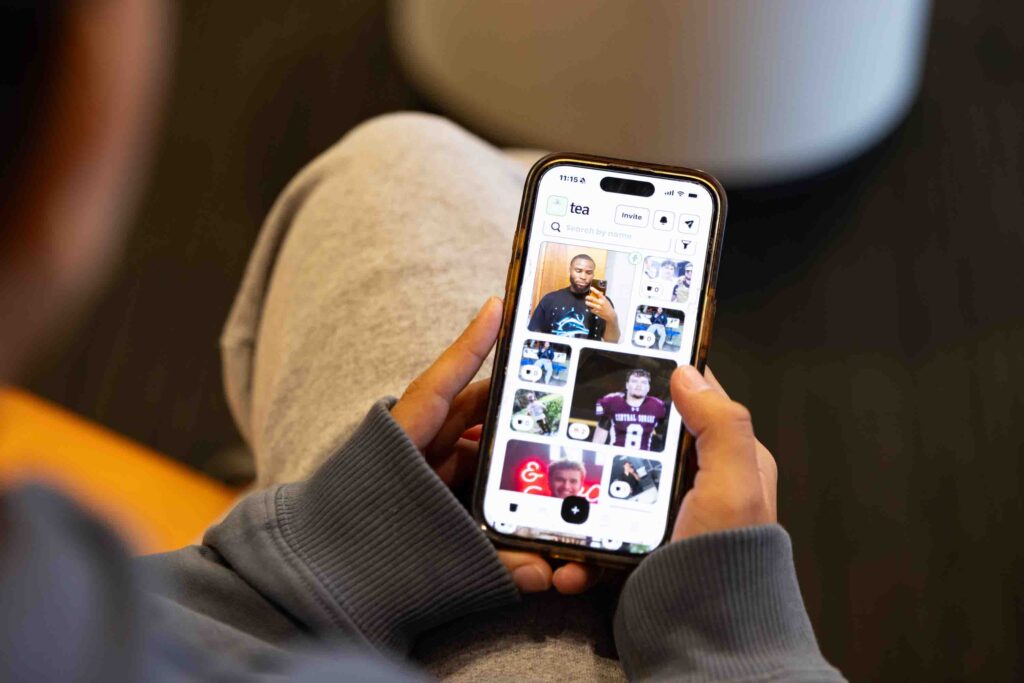 A student who would prefer not to be named scrolls through the Tea App home page on their phone.
