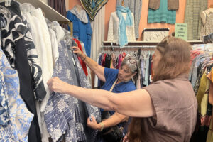 A pair of shoppers examine a top at EcoChic Boutique on East Genesee Street.
