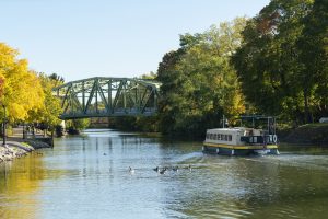 A tour boat designed to look like an original Erie Canal-era boat cruises the Erie Canal near Pittsford, New York.