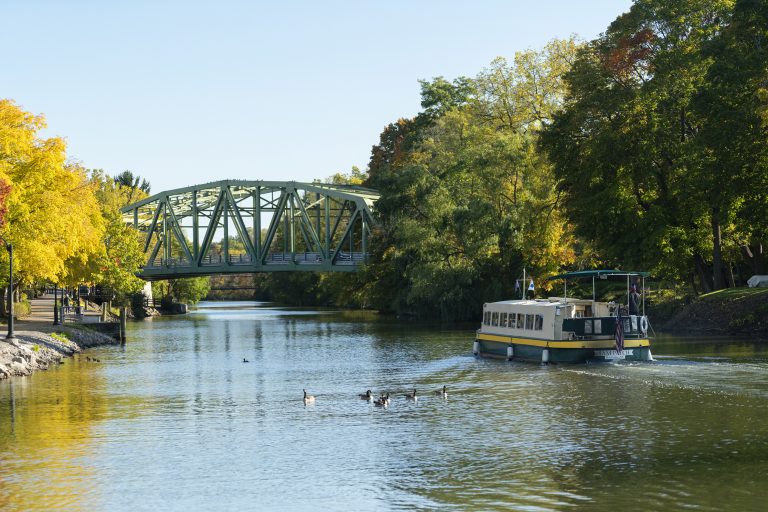 A tour boat designed to look like an original Erie Canal-era boat cruises the Erie Canal near Pittsford, New York.