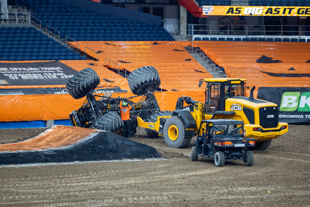 Grounds crew work to upright a turned over truck at the driver rehearsal in the JMA Wireless Dome Friday 10/23/26 ahead of Monster Jam