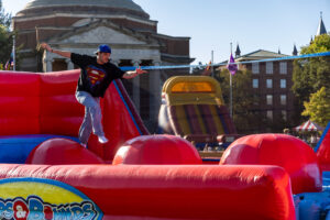 A student jumps across the inflatable obstacle course during Quad-a-Palooza on Friday, Sept. 25, 2026 on The Quad.
