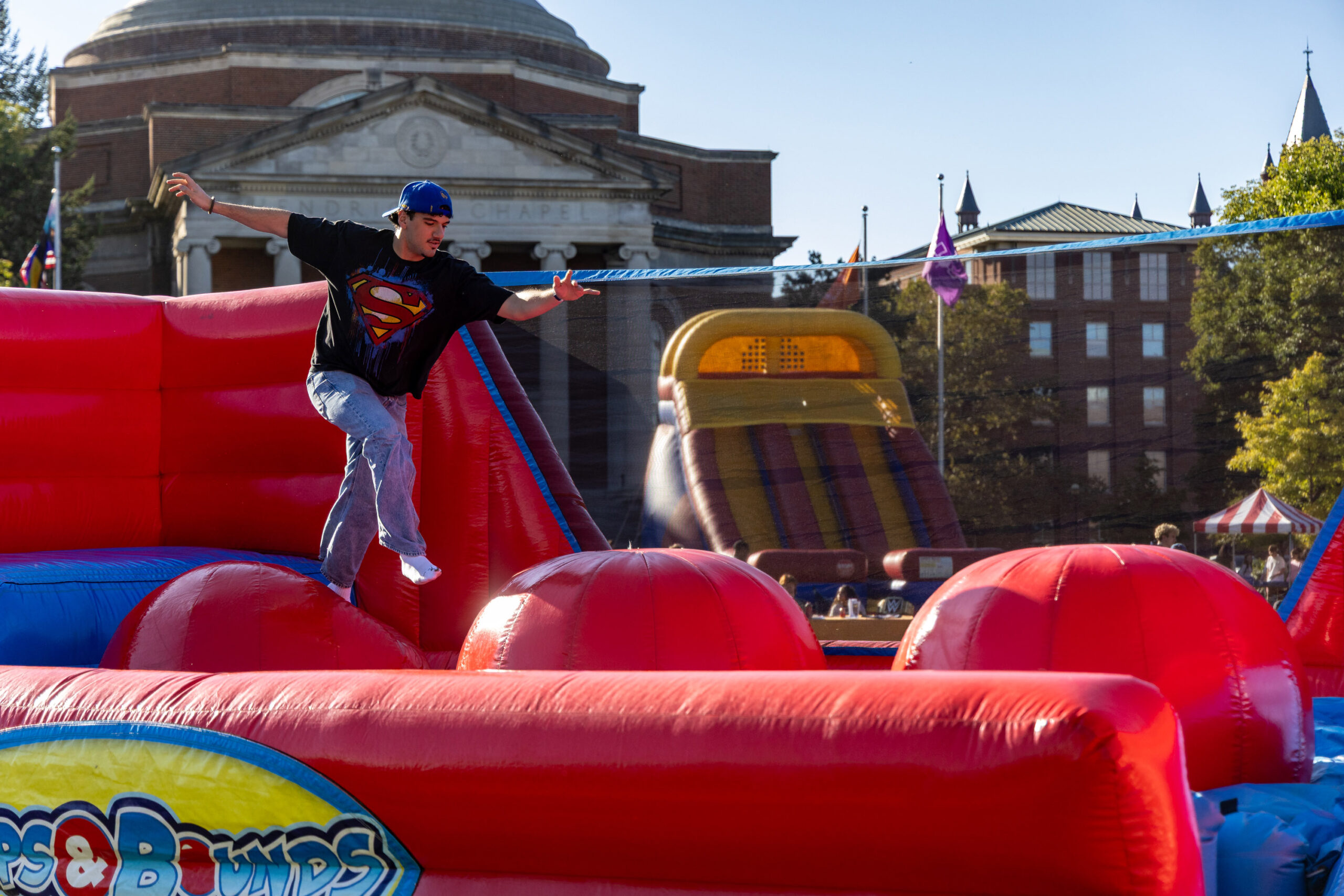 A student jumps across the inflatable obstacle course during Quad-a-Palooza on Friday, Sept. 25, 2026 on The Quad.