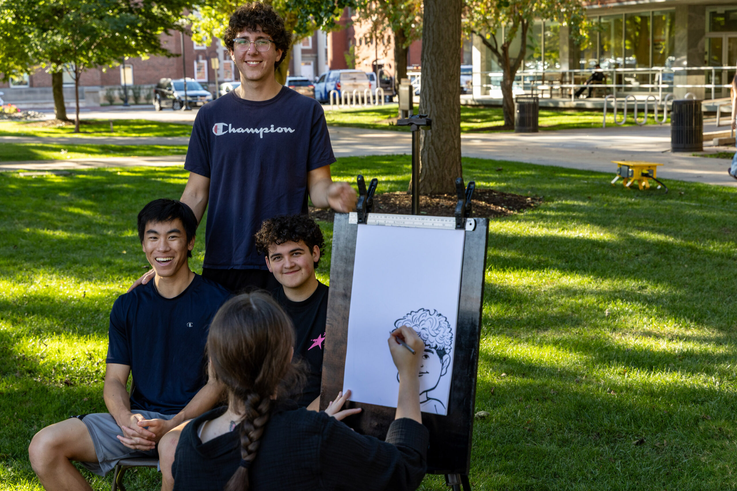 Students sit for a caricature drawing during Quad-a-Palooza on Friday, Sept. 25, 2026 on The Quad.