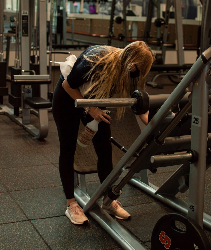 Employees at the Barnes Center at Syracuse University clean and sanitize the exercise equipment.