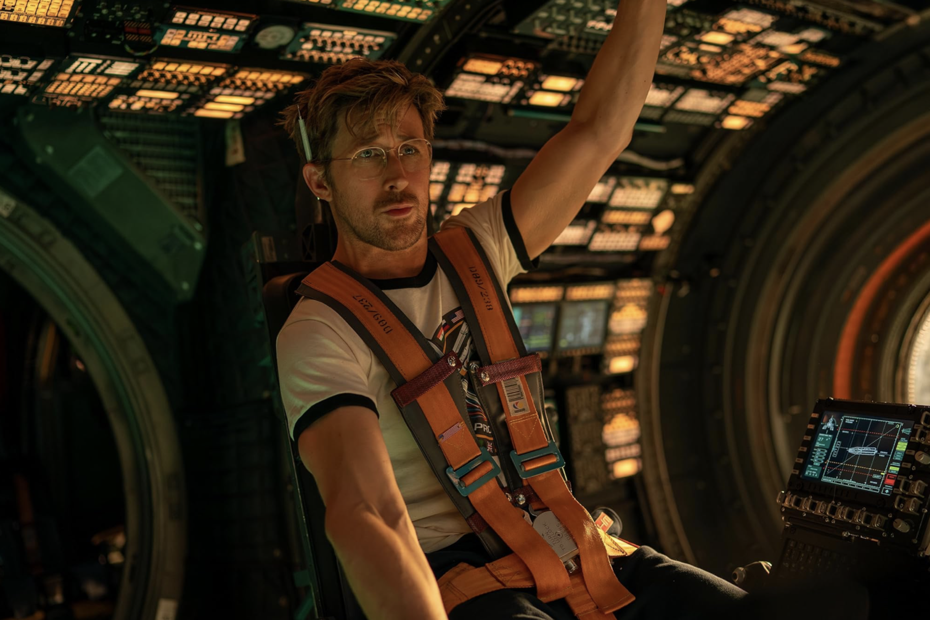 In "Project Hail Mary" Ryan Gosling dressed in a t-shirt and glasses floats in a spaceship.