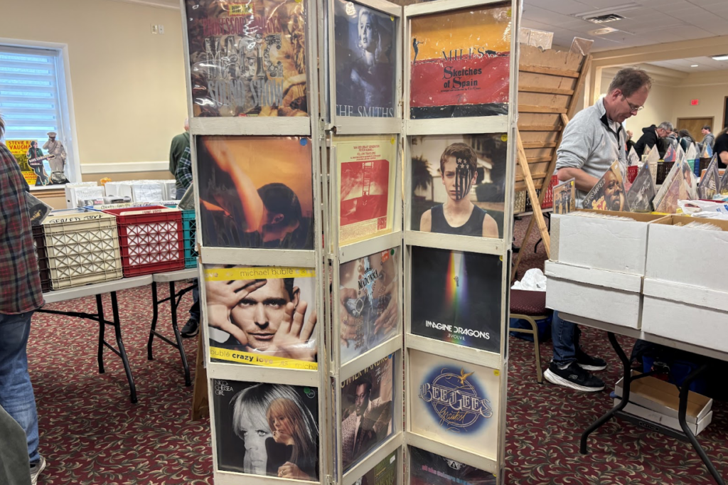 At the Syracuse Records and CD Fair, a stand of vinyl records sits in the middle of an aisle.