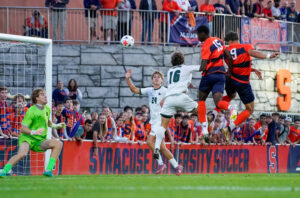 Syracuse freshman defender Emmanuel Cophy and graduate student forward Pedro Gulli go up for a header. against Loyola Maryland players on Friday, Aug. 28, 2026. at SU Soccer Stadium.