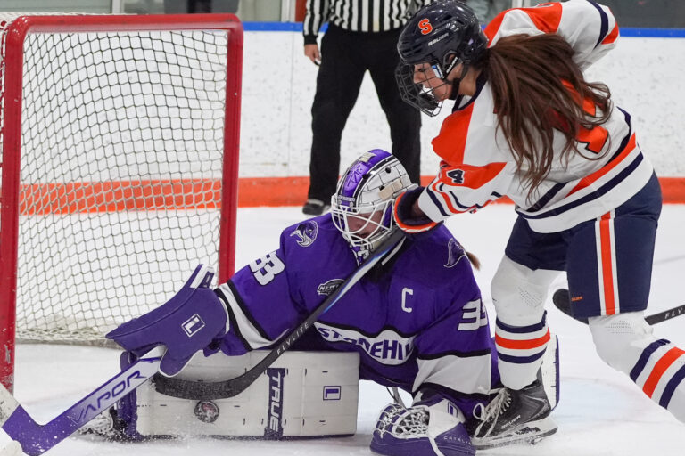 Syracuse forward Jordan Blouin's shot hits off the leg of Stonehill goalie Alexsa Caron on Friday, September 25, 2026, at the Tennity Ice Pavilion.