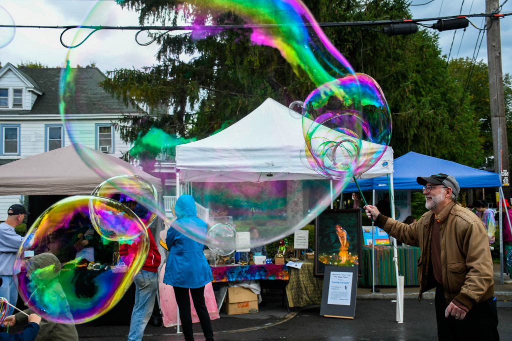 Jim Vili blowing a giant bubble. at the Westcott Street Cultural Fair