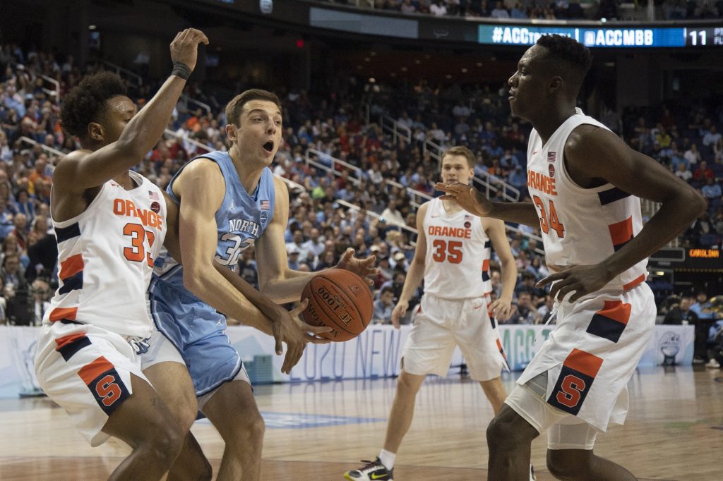 UNC graduate forward Justin Pierce (32) fights for possession of the ball against Syracuse in the second round of the 2020 New York Life ACC Tournament held in the Greensboro Coliseum in Greensboro, N.C., on Wednesday, March 11, 2020. UNC lost 81-53.